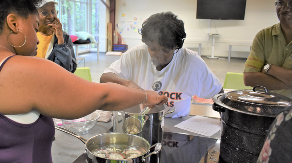 Women work at a kitchen to serve the community